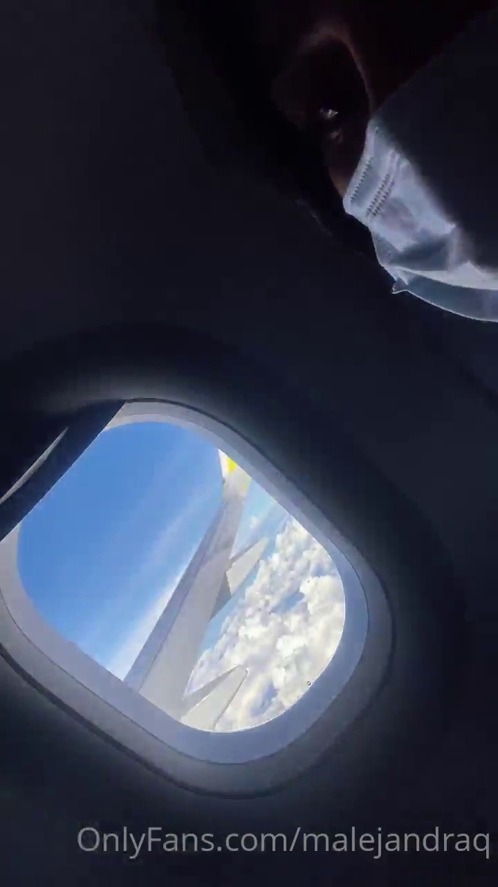 Brunette finguering herself on the plane